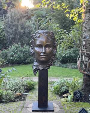A vibrant scene at Abbotsbury Subtropical Gardens with orange and yellow flowers under a blue sky.