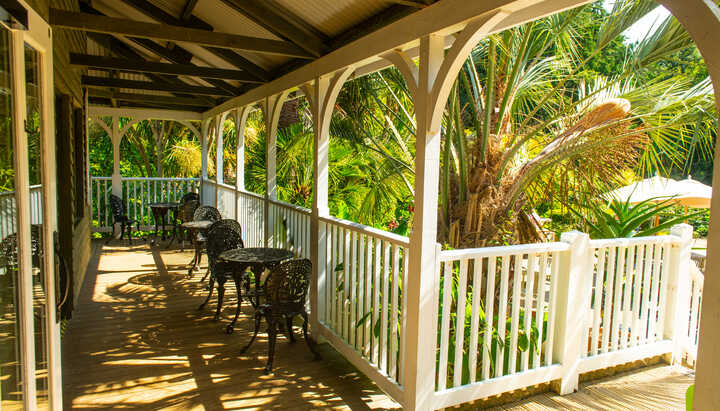 outdoor seating on the veranda at the cafe building at abbotsbury subtropical gardens