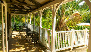 outdoor seating on the veranda at the cafe building at abbotsbury subtropical gardens